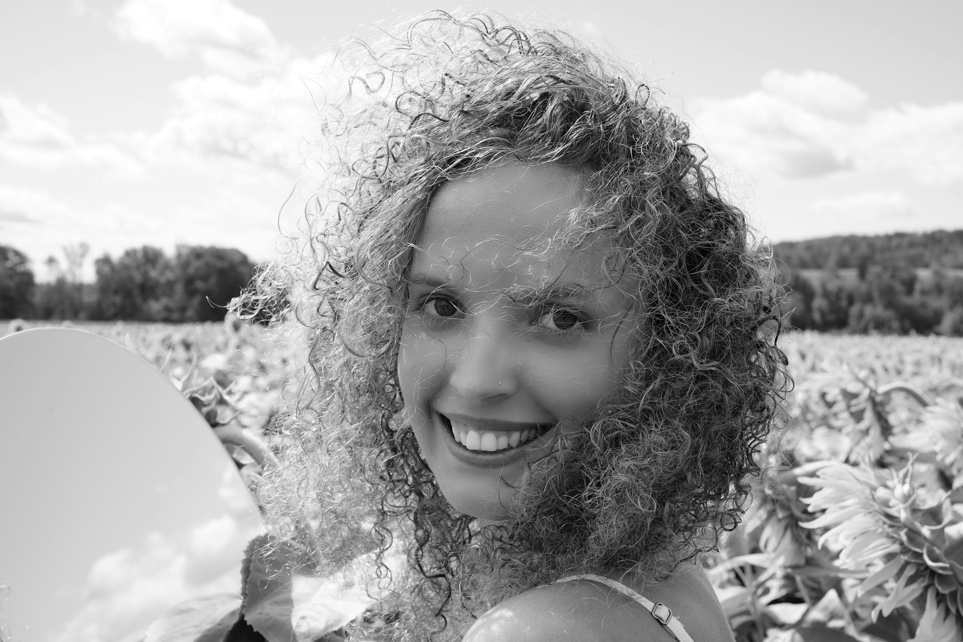 a woman standing in a field of sunflowers